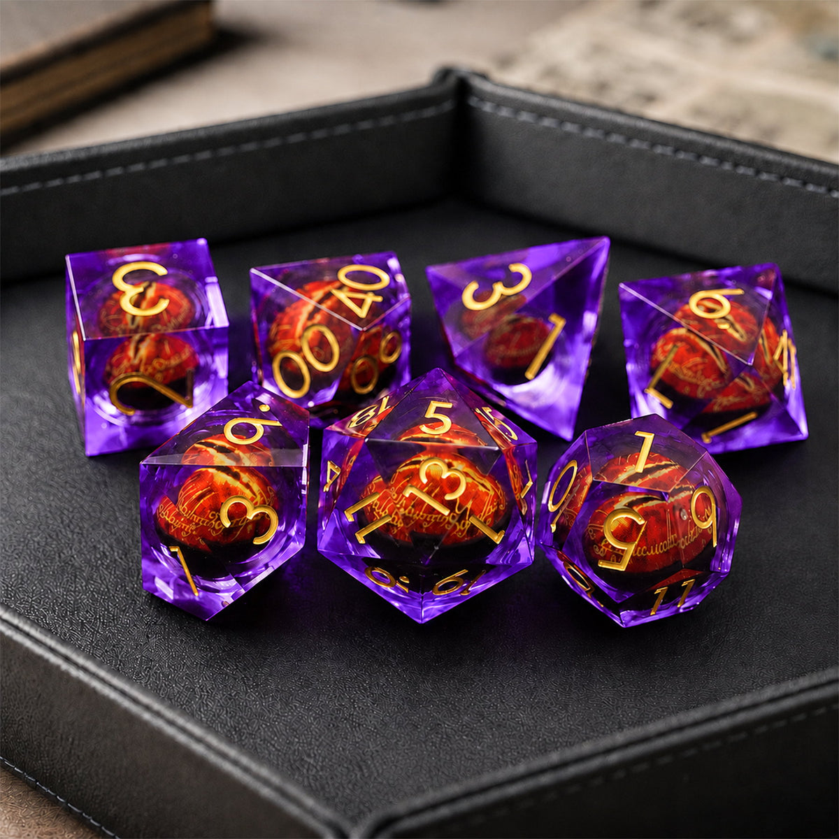 Amethyst Flame Dragon Eye 7-piece violet liquid core DND dice set with red dragon eyes and gold numbers in a black dice tray.