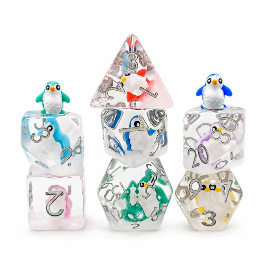 Colorful Penguin 7-piece clear resin embedded DND dice set with penguin figures on white background.