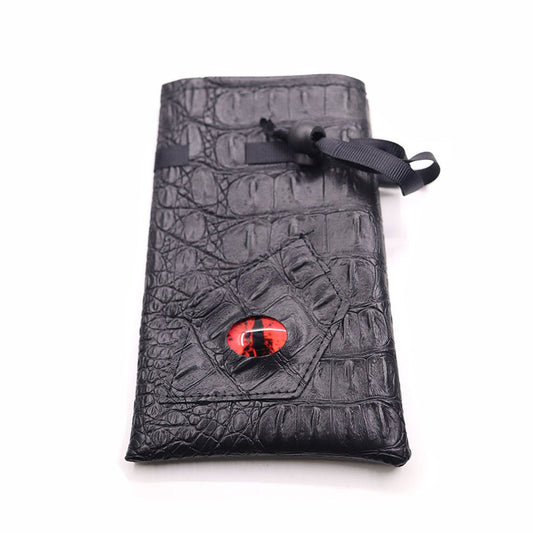 Crimson Eye black textured drawstring DND dice bag with red dragon eye design laid flat on white background.