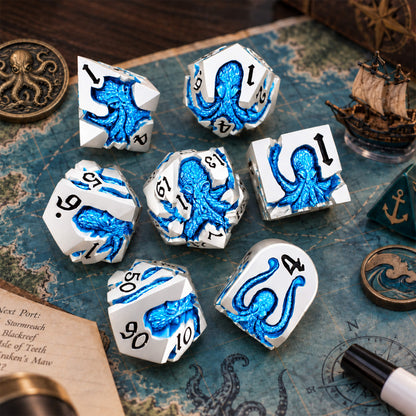 Cold Current Kraken 7-piece silver-tone metal DND dice set with blue pearlescent kraken designs displayed on a nautical map with ocean-themed props.