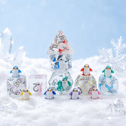 Colorful Penguin 7-piece resin DND dice set in a snowy scene with tiny penguin figures and crystals.