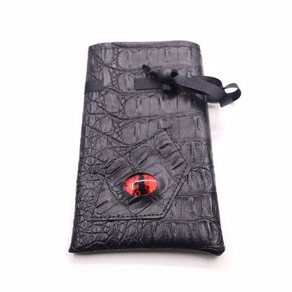 Crimson Eye black textured drawstring DND dice bag with red dragon eye design laid flat on white background.