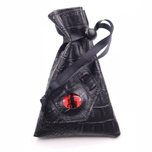 Crimson Eye black textured drawstring DND dice bag with drawstring pulled tight and red dragon eye on white background.