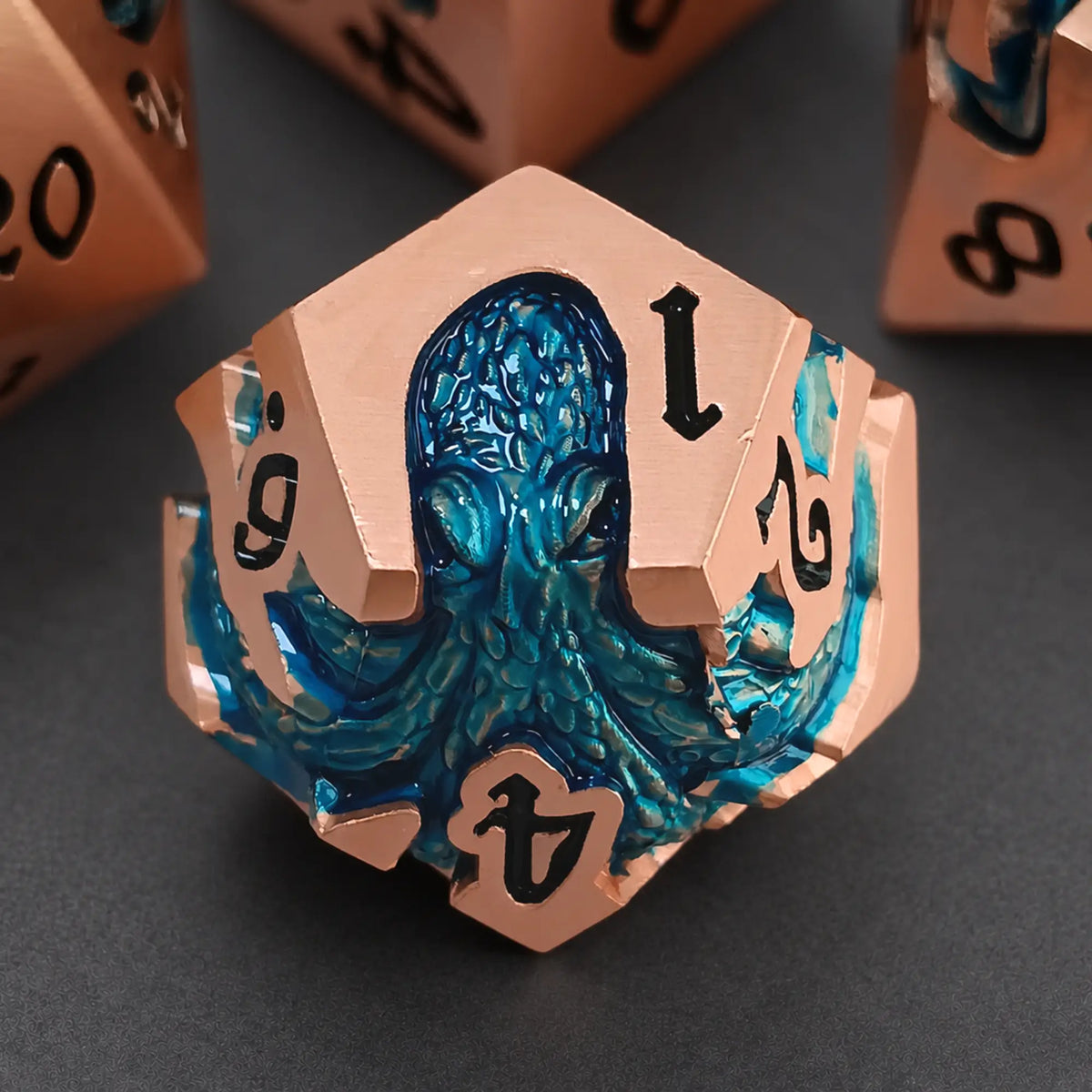 Dawnthaw Kraken rose gold D12 with blue kraken design and black numbers.