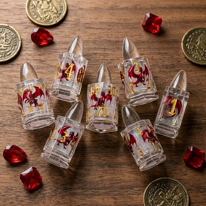 Dragonshot bullet-shaped liquid core DND dice arranged on a wooden tabletop with coins and red crystals.