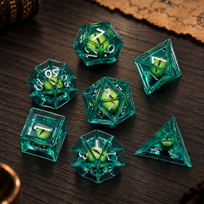 Emerald Dragon Eye 7-piece green liquid core DND dice set with green dragon eyes and silver numbers on a dark wood tabletop.