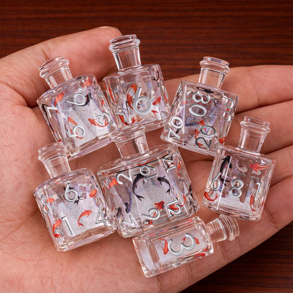 Fortune Koi 7-piece clear resin liquid core DND dice set with koi motifs held in hand.