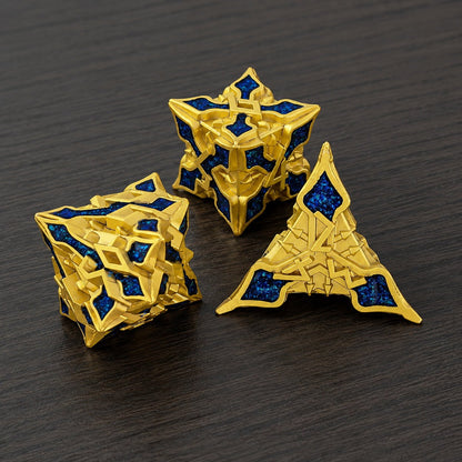 Golden Knight Series close-up of three gold-toned metal DND dice with blue glitter inlays on a dark wood tabletop.