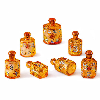 Honeyed Vial 7-piece amber resin liquid core DND dice set with bee and flower motifs on white background.