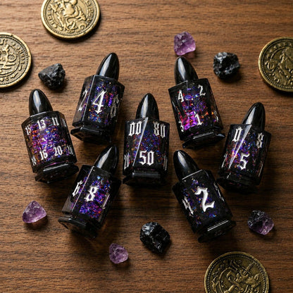 Midnight Assassin bullet-shaped liquid core DND dice arranged on a wooden tabletop with coins and dark crystals.