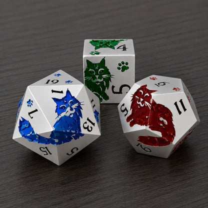 Moonwhisker close-up of three silver-white metal DND dice with colorful cat designs on a dark wood tabletop.