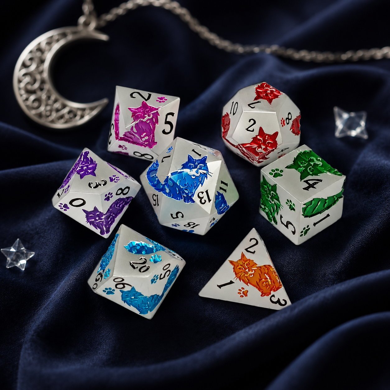 Moonwhisker 7-piece metal DND dice set with colorful cat motifs on deep blue velvet beside a moon charm.