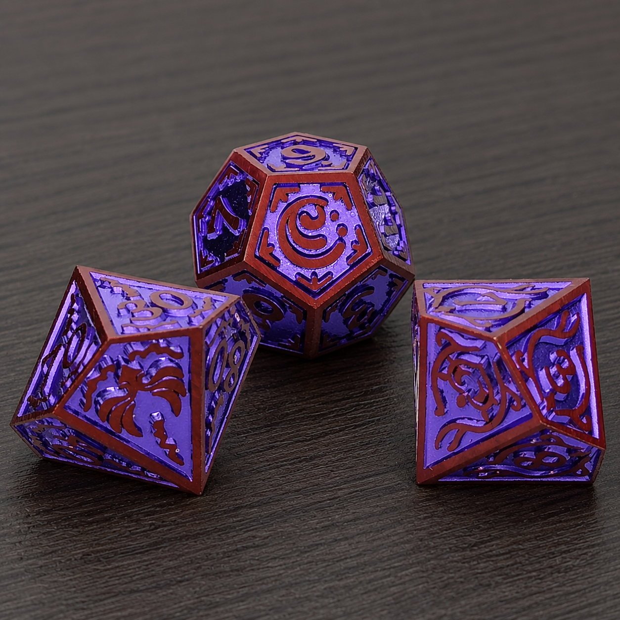 Starseer Oracle close-up of three purple metal DND dice with red frames on a dark wood tabletop.