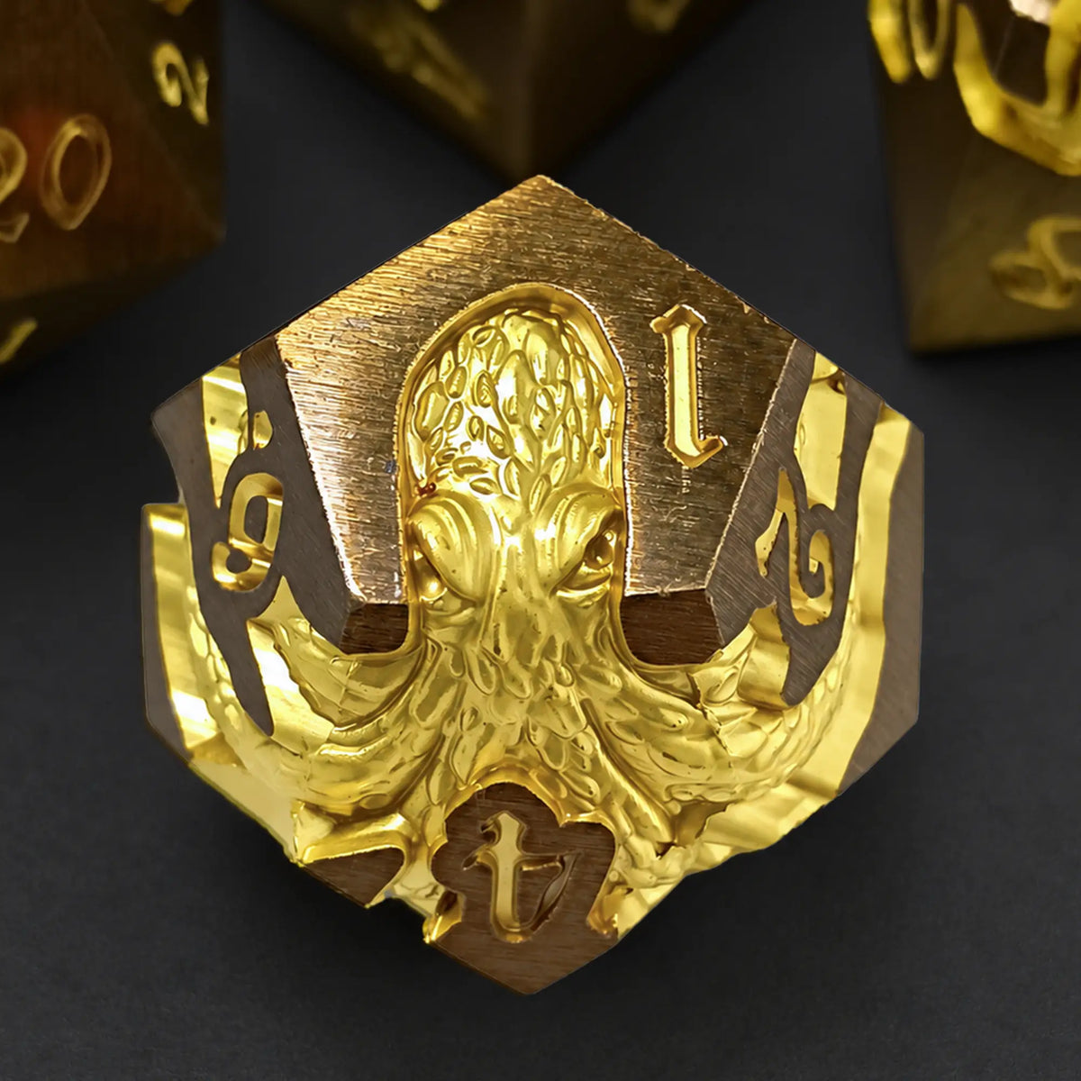 Sunken Crown Kraken gold metal D12 with bright gold kraken design and engraved numbers.