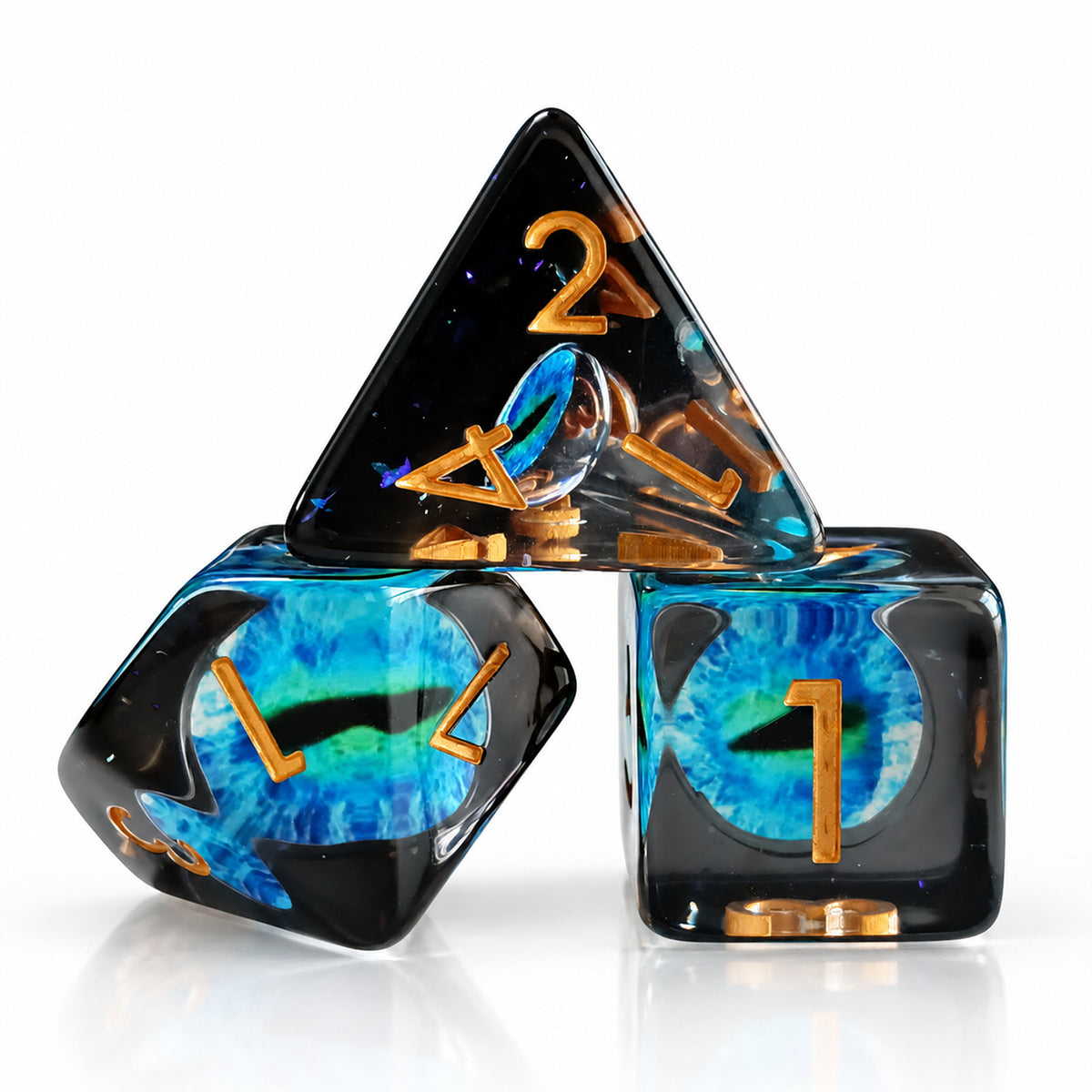 Tidal Dragon Eye close-up of three black resin DND dice with blue-green dragon eyes and gold numbers on a white reflective surface.