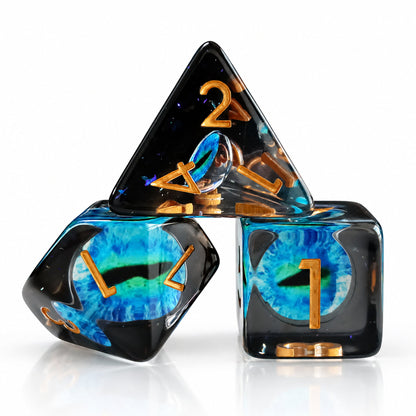 Tidal Dragon Eye close-up of three black resin DND dice with blue-green dragon eyes and gold numbers on a white reflective surface.